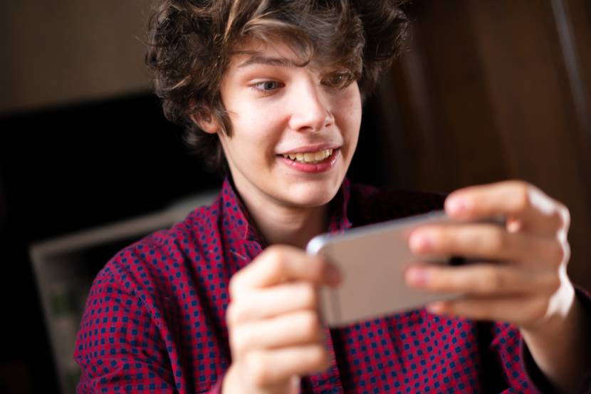 teenagers watching something on his phone
