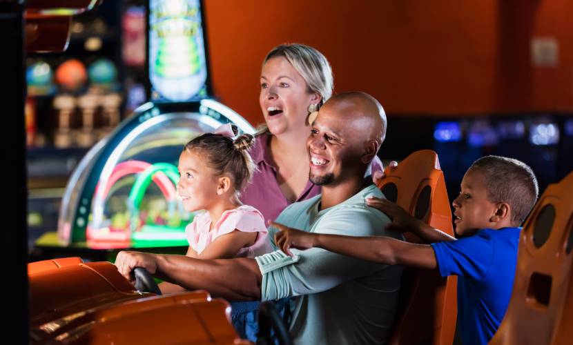 adults playing a video game with children