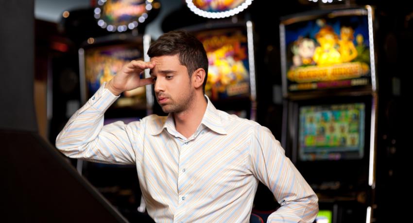 person sitting in front of a gambling machine