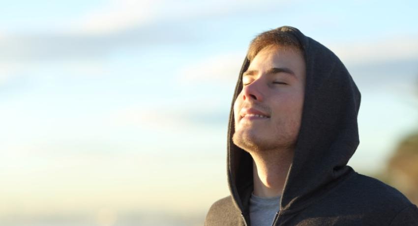 Young man with sun shining on face